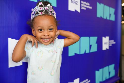 Young girl wearing tiara smiling