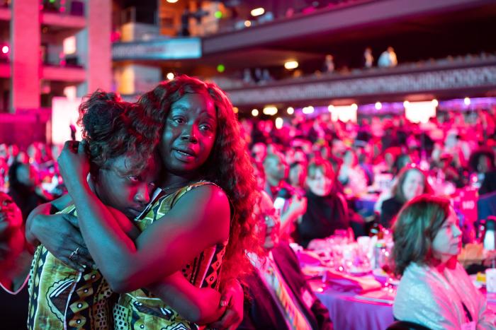 Mother and daughter hug each other with tears in their eyes.