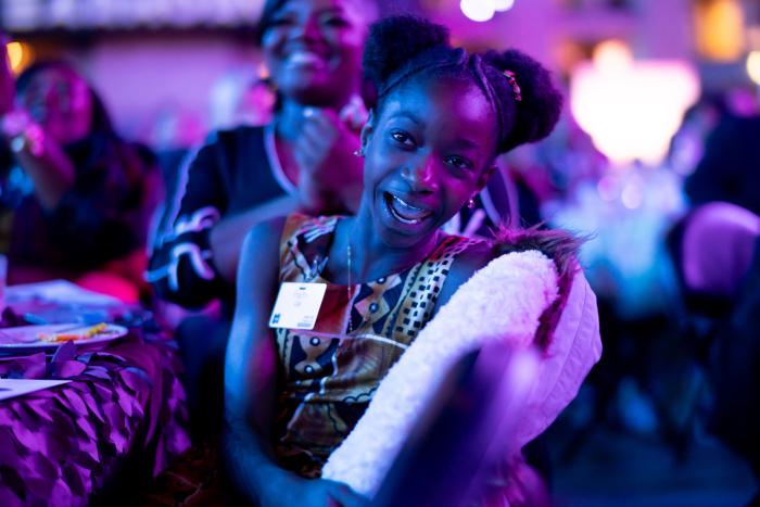 A young girl smiles at the camera