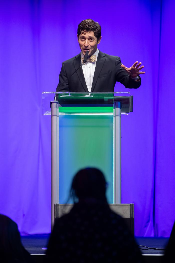 A man stands at a podium