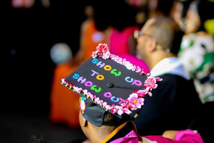 Graduation cap reading "Show up to show out"