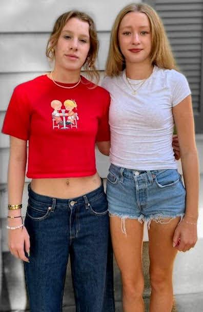 Two teen girls stand next to each other